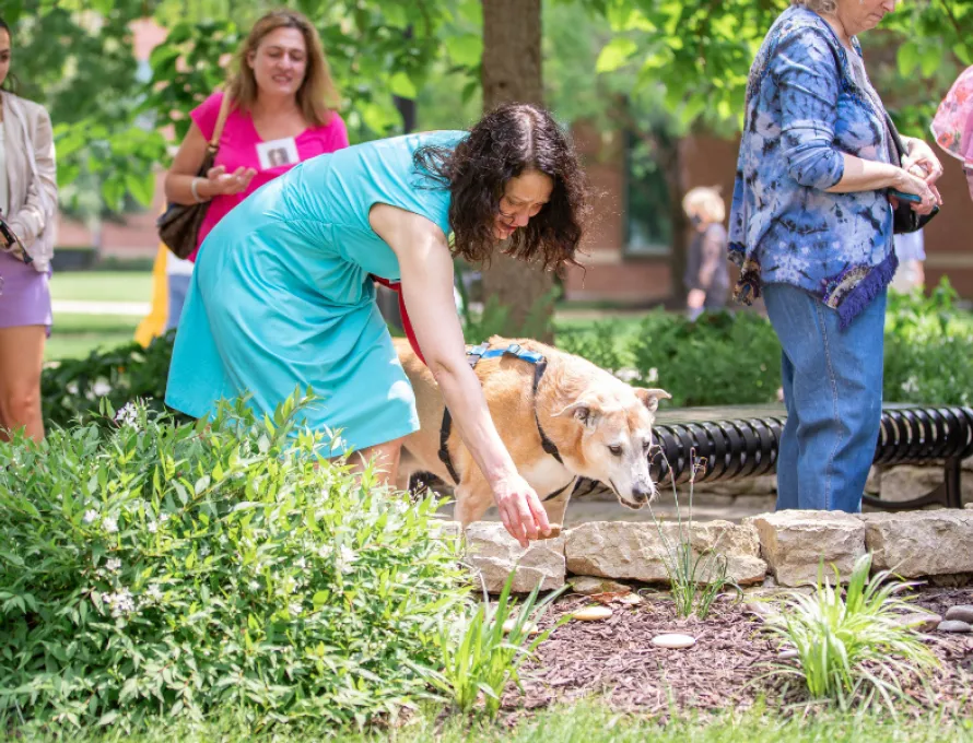 woman and dog at animal remembrance ceremony in may 2022