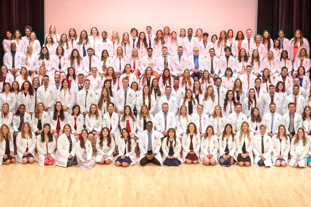 class of 2024 in their white coats in april 2023
