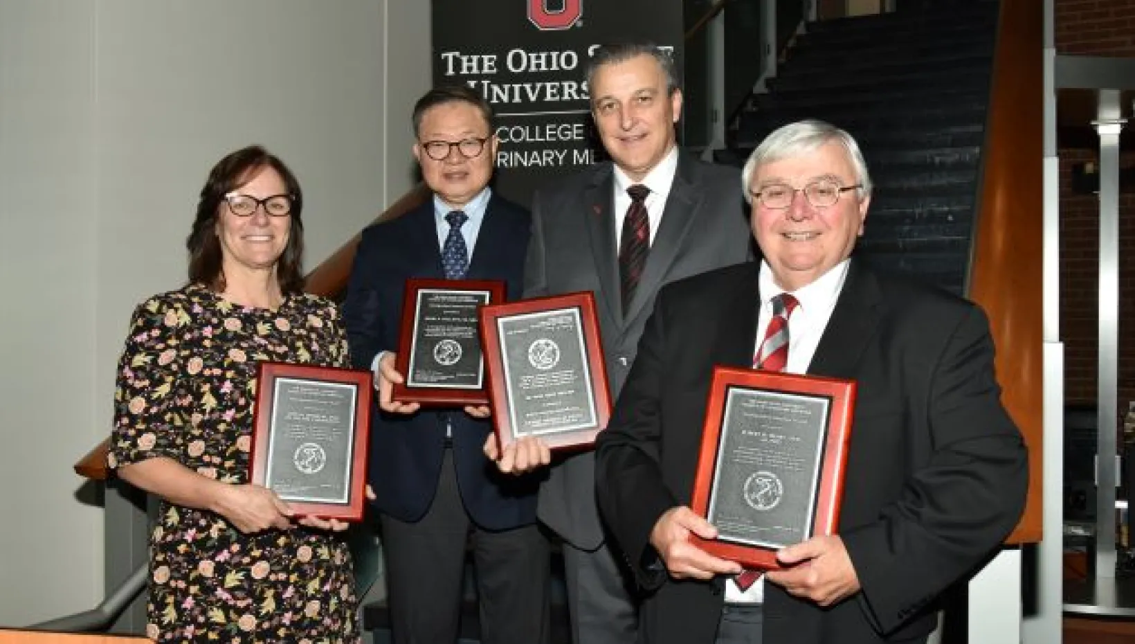Four people receiving awards from The Ohio State University College of Veterinary Medicine