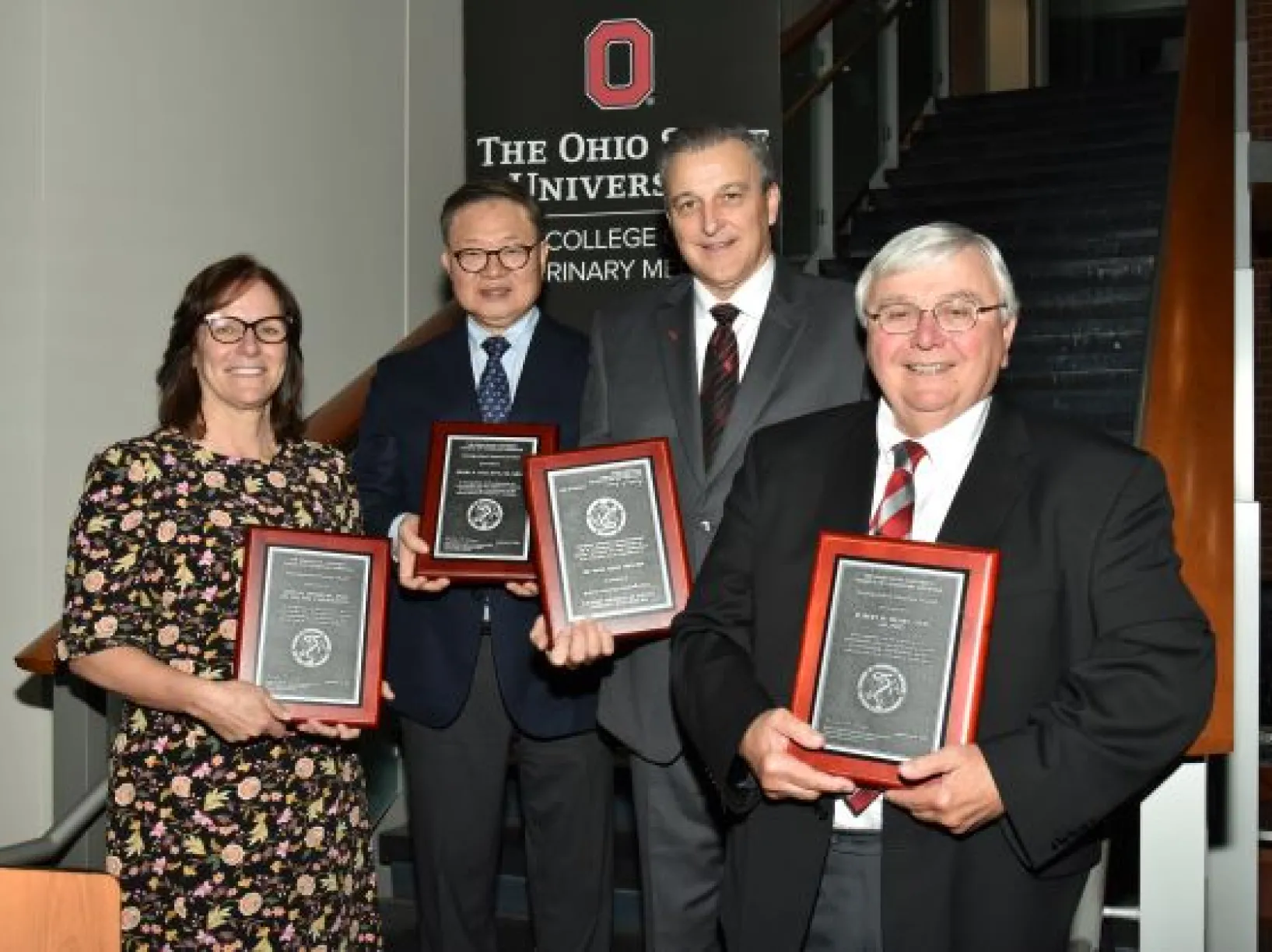 Four people receiving awards from The Ohio State University College of Veterinary Medicine