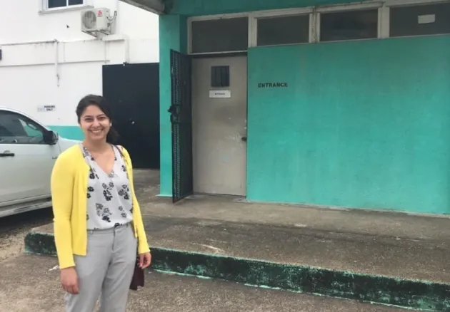 Student stands in front of building in Belize in 2020