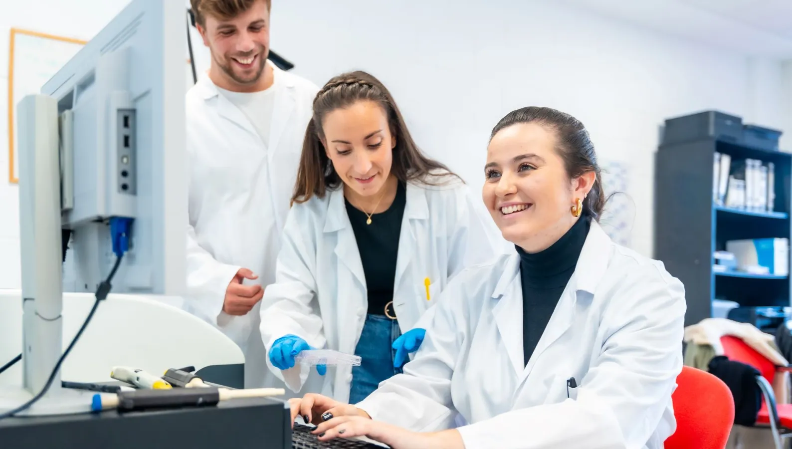 Three young doctors working in a scholarship in a laboratory