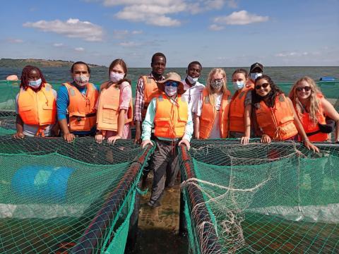 Richley at fish farm with students 